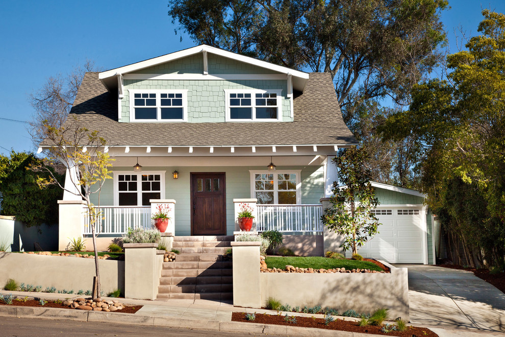 Small arts and crafts two-storey green exterior in San Diego with wood siding.
