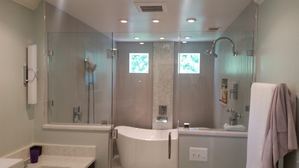 Freestanding bathtub - mid-sized transitional master beige tile and porcelain tile porcelain tile and beige floor freestanding bathtub idea in DC Metro with shaker cabinets, dark wood cabinets, green walls, an undermount sink, quartz countertops and a hinged shower door