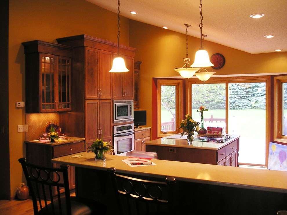 Eat-in kitchen - mid-sized l-shaped light wood floor eat-in kitchen idea in Minneapolis with an undermount sink, flat-panel cabinets, red cabinets, quartz countertops, beige backsplash, ceramic backsplash, stainless steel appliances and an island