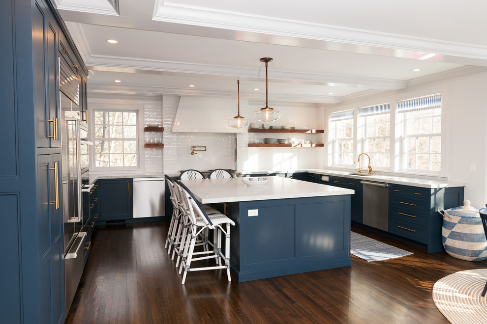 Inspiration for a large country u-shaped eat-in kitchen in New York with an undermount sink, shaker cabinets, blue cabinets, quartz benchtops, white splashback, subway tile splashback, stainless steel appliances, dark hardwood floors, with island, brown floor and white benchtop.