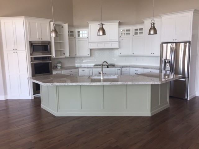 Design ideas for a mid-sized contemporary u-shaped eat-in kitchen in Salt Lake City with an undermount sink, shaker cabinets, white cabinets, granite benchtops, white splashback, subway tile splashback, stainless steel appliances, dark hardwood floors and with island.