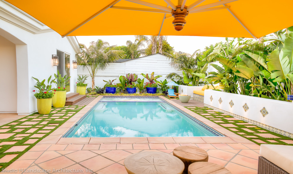 Inspiration for a mid-sized mediterranean backyard rectangular lap pool in Los Angeles with a hot tub and tile.