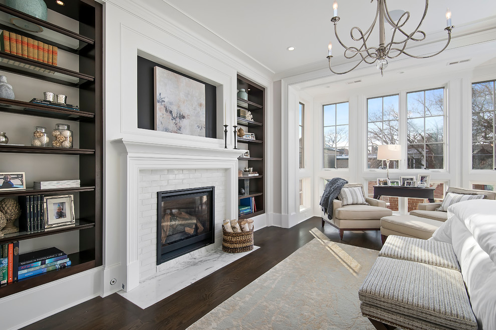 Inspiration for a traditional master bedroom in Chicago with white walls, dark hardwood floors and a standard fireplace.