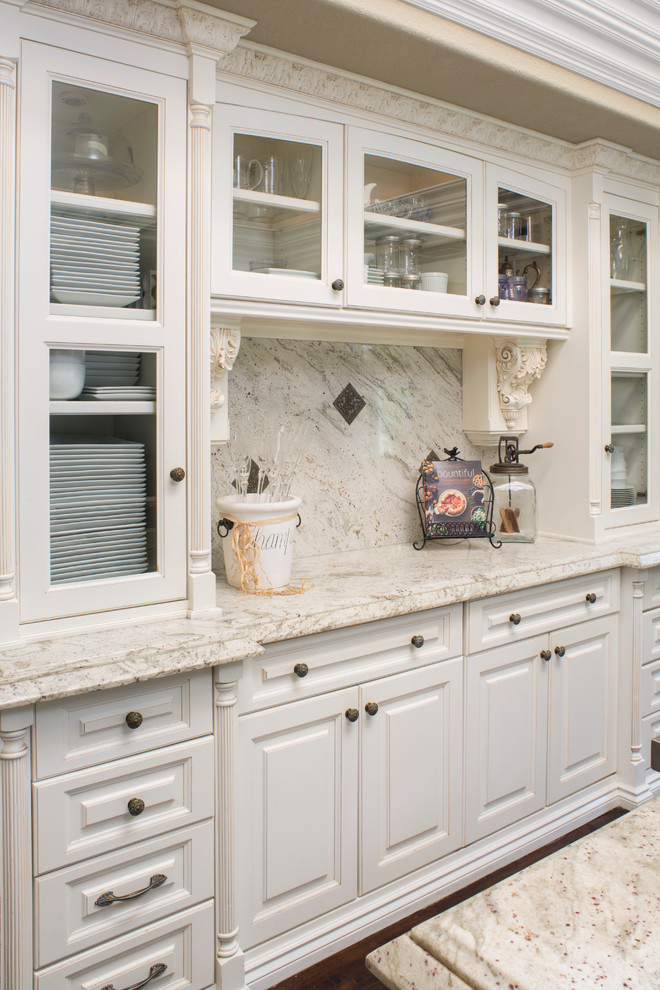Open concept kitchen - large transitional u-shaped dark wood floor open concept kitchen idea in Orange County with an undermount sink, raised-panel cabinets, white cabinets, granite countertops, white backsplash, stone slab backsplash, stainless steel appliances and an island
