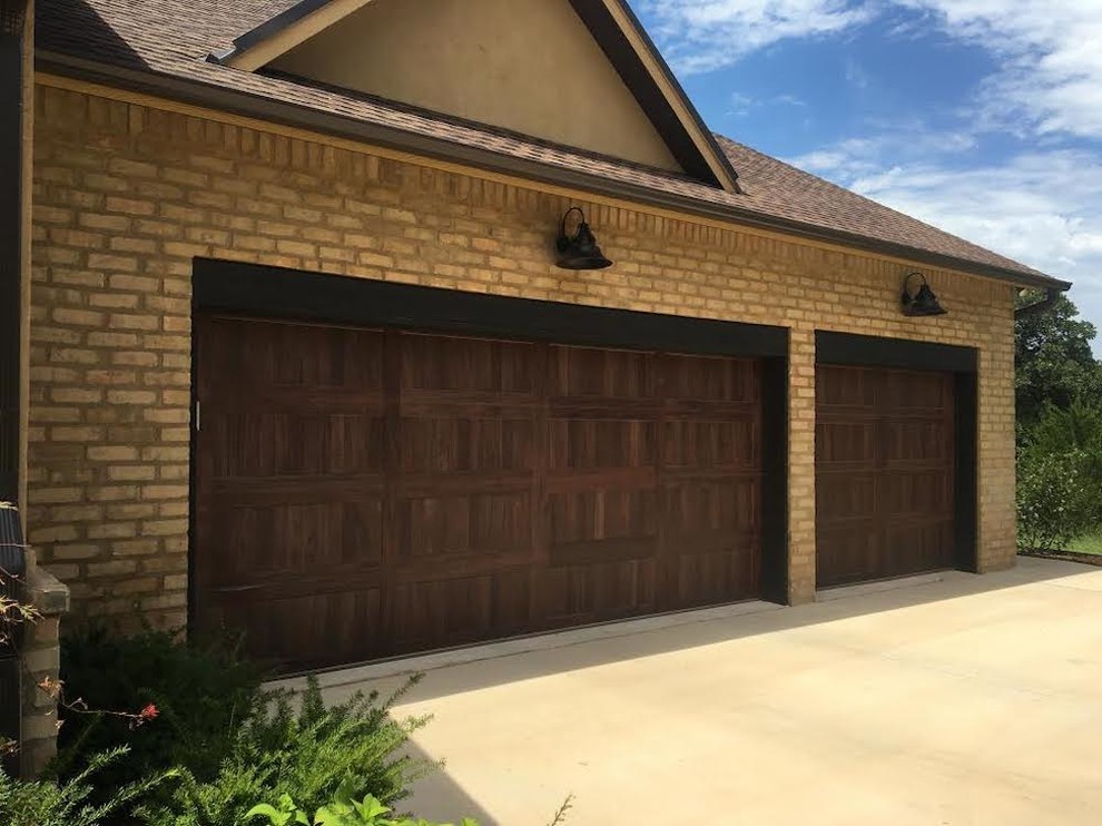 Inspiration for a mid-sized traditional attached three-car garage in Oklahoma City.