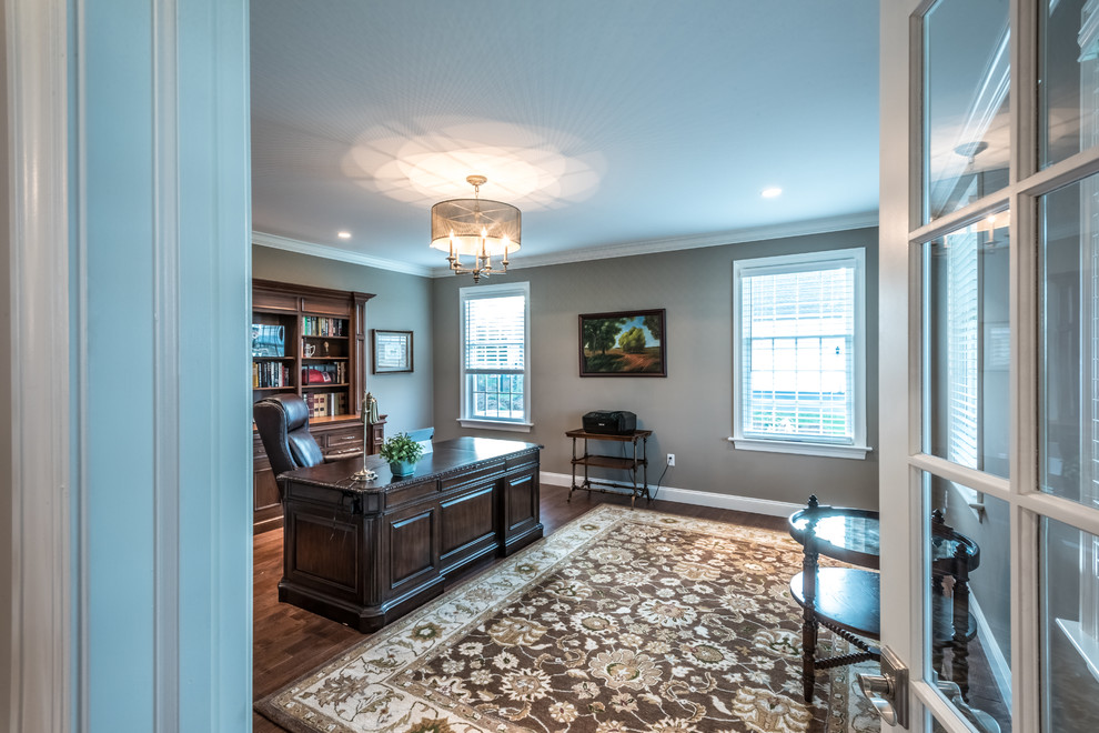 Inspiration for a large transitional freestanding desk medium tone wood floor study room remodel with gray walls and no fireplace