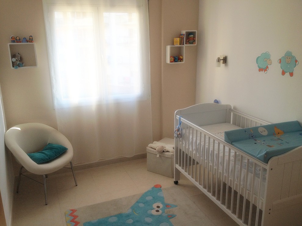 This is an example of a small transitional gender-neutral nursery in Other with beige walls and ceramic floors.