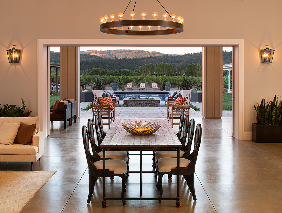 Inspiration for a country open plan dining in San Francisco with concrete floors.