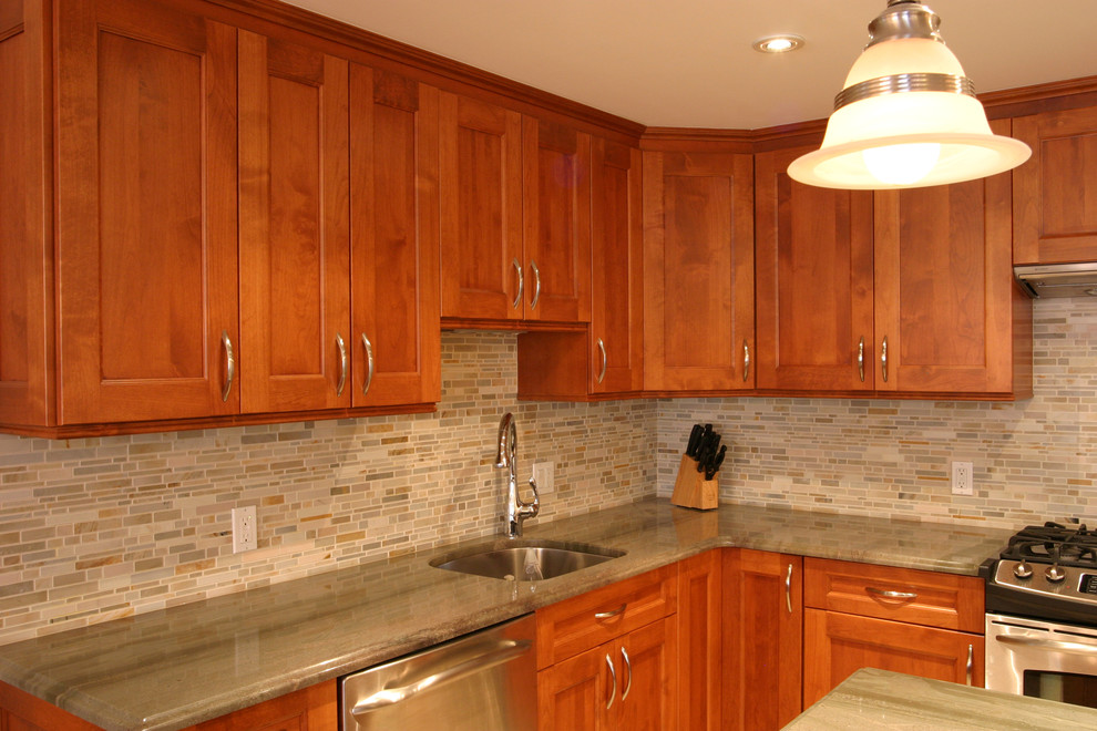 Eat-in kitchen - large transitional l-shaped porcelain tile eat-in kitchen idea in New York with an undermount sink, shaker cabinets, medium tone wood cabinets, quartzite countertops, multicolored backsplash, mosaic tile backsplash, stainless steel appliances and an island