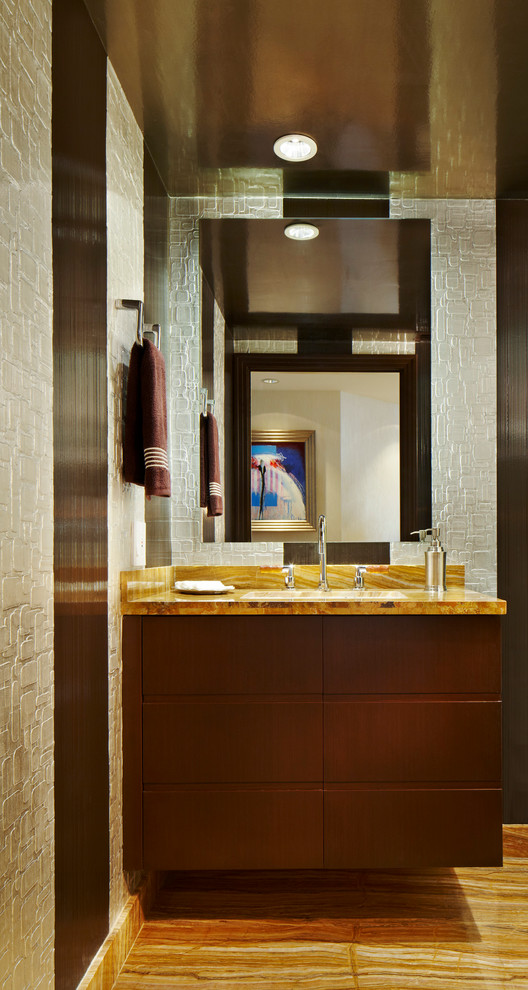 Photo of a small contemporary powder room in Miami with flat-panel cabinets, dark wood cabinets, stone slab, beige walls, marble floors, a drop-in sink, onyx benchtops and yellow benchtops.