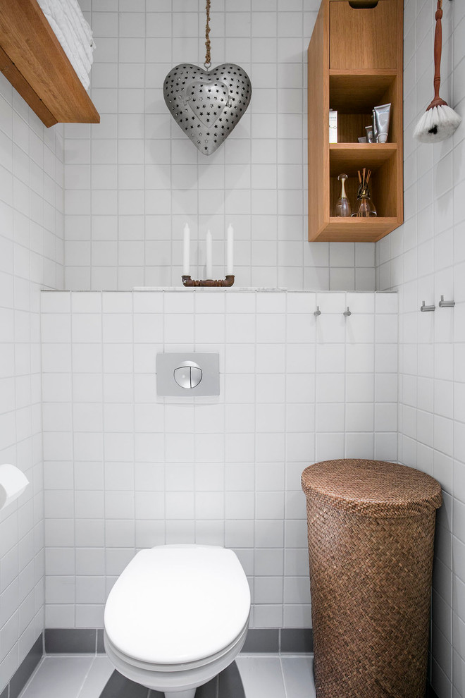 Small transitional powder room in Malmo with open cabinets and medium wood cabinets.
