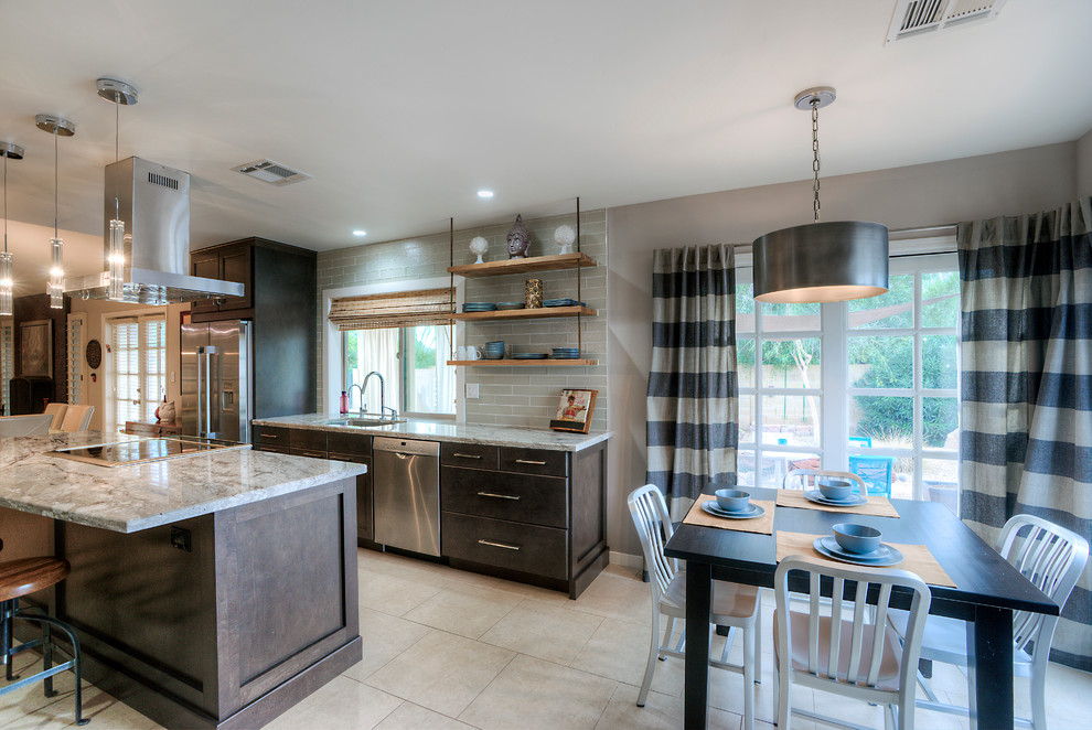Inspiration for a large transitional galley eat-in kitchen in Phoenix with an undermount sink, shaker cabinets, granite benchtops, beige splashback, stainless steel appliances, with island, subway tile splashback, porcelain floors, brown cabinets and beige floor.