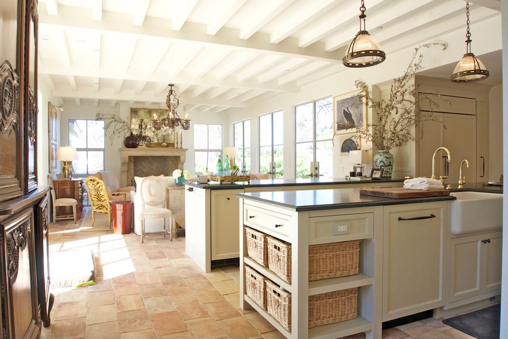 This is an example of a mid-sized country open plan kitchen in San Diego with a farmhouse sink, recessed-panel cabinets, beige cabinets, granite benchtops, terra-cotta floors and with island.