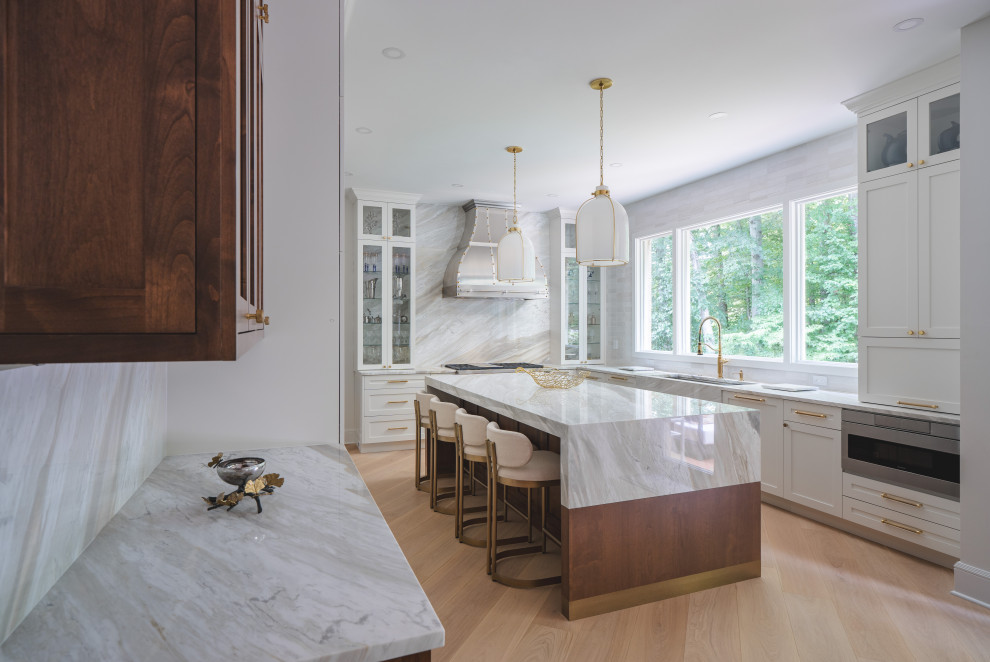 Inspiration for a large transitional u-shaped light wood floor and brown floor eat-in kitchen remodel in DC Metro with an undermount sink, shaker cabinets, white cabinets, quartzite countertops, white backsplash, quartz backsplash, stainless steel appliances, an island and white countertops