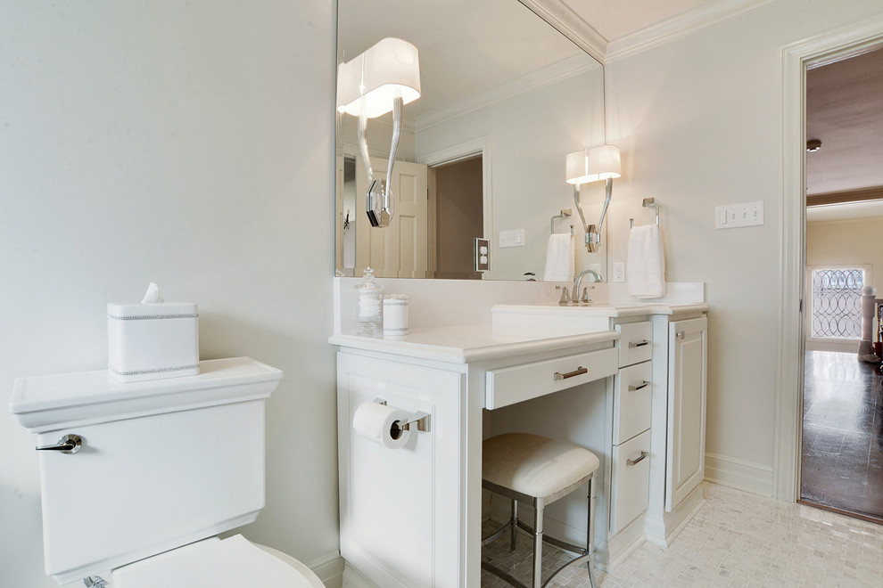 Design ideas for a mid-sized transitional master bathroom in New Orleans with raised-panel cabinets, white cabinets, an alcove tub, a shower/bathtub combo, a two-piece toilet, gray tile, white tile, stone tile, white walls, marble floors and an undermount sink.