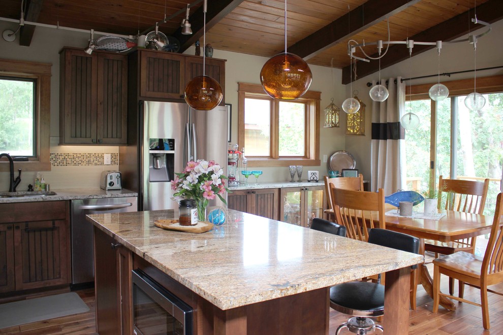 Eat-in kitchen - mid-sized rustic l-shaped light wood floor eat-in kitchen idea with a drop-in sink, dark wood cabinets, granite countertops, beige backsplash, stainless steel appliances and an island