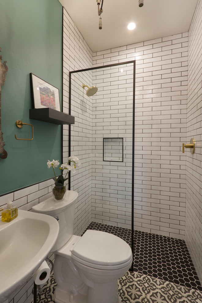 This is an example of a mid-sized master bathroom in Phoenix with a curbless shower, a two-piece toilet, white tile, porcelain tile, cement tiles, white benchtops, green walls, a pedestal sink, black floor and an open shower.