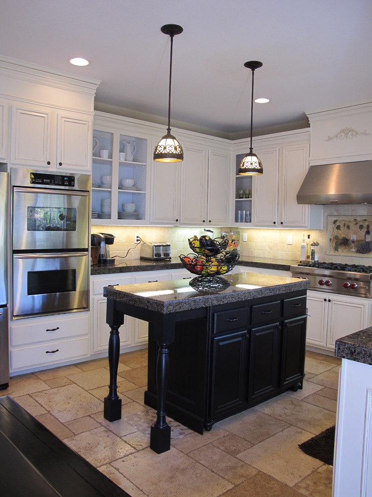 Traditional kitchen in San Diego with white cabinets, beige splashback, stainless steel appliances and beige floor.