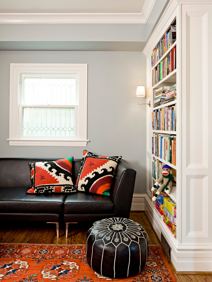 This is an example of a traditional family room in Portland with a library.