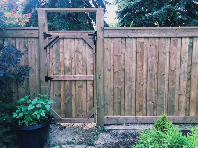 Wood privacy fence with matching residential gate