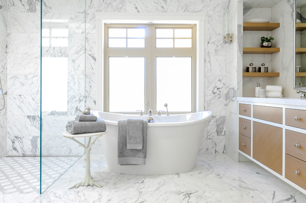 Design ideas for a transitional bathroom in Vancouver with flat-panel cabinets, medium wood cabinets, a freestanding tub and white floor.