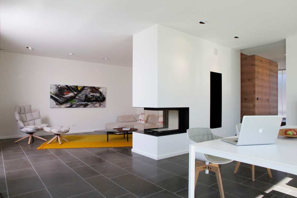 Inspiration for a contemporary open concept living room in Nuremberg with a standard fireplace.