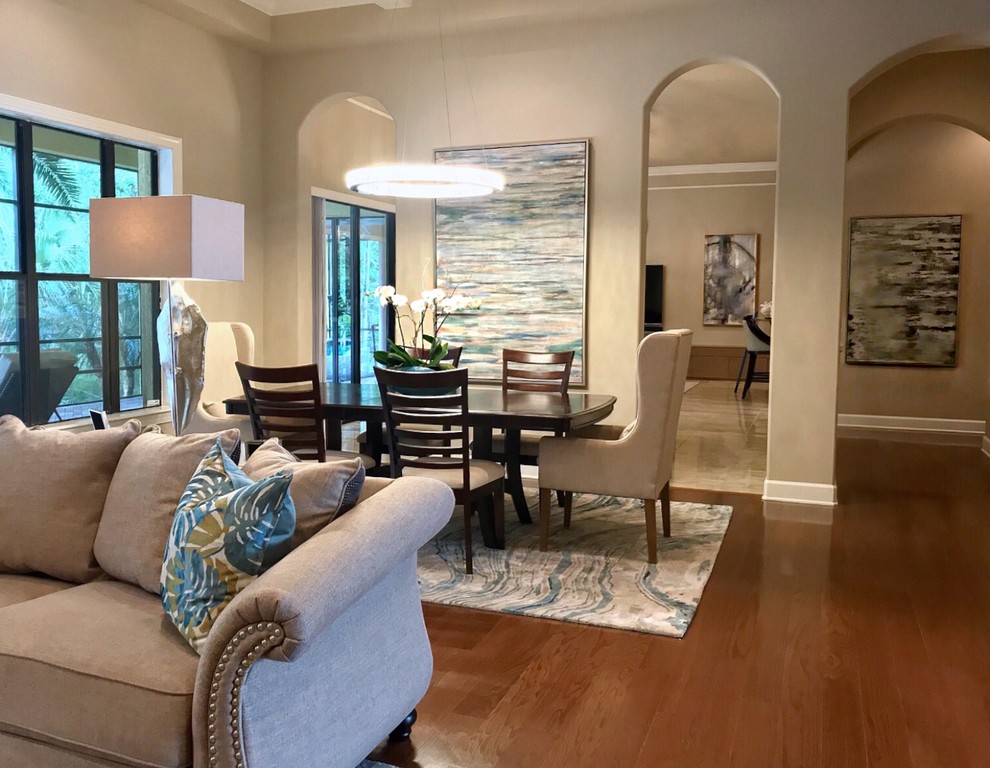 Inspiration for a mid-sized transitional brown floor great room remodel with beige walls, a standard fireplace and a stone fireplace