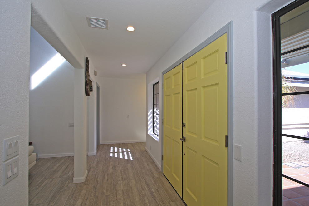 Inspiration for a small transitional foyer in Other with white walls, porcelain floors, a double front door, a yellow front door and grey floor.