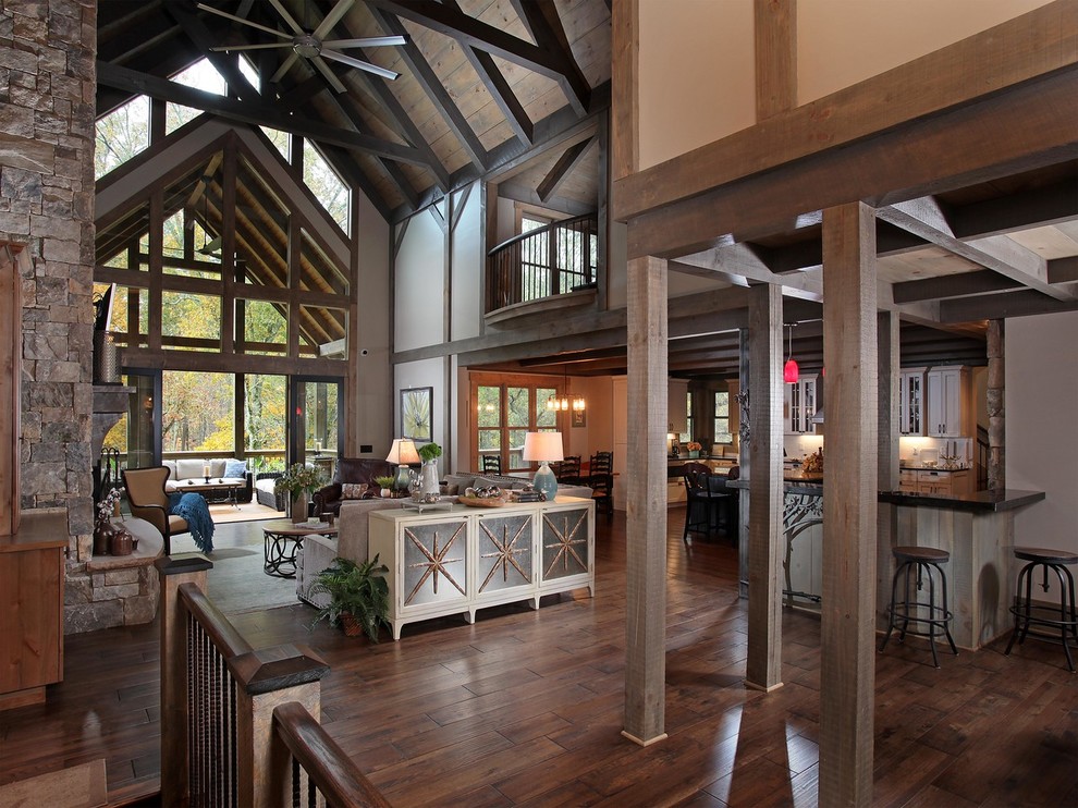 Inspiration for a country open concept family room in Atlanta with beige walls, dark hardwood floors and brown floor.