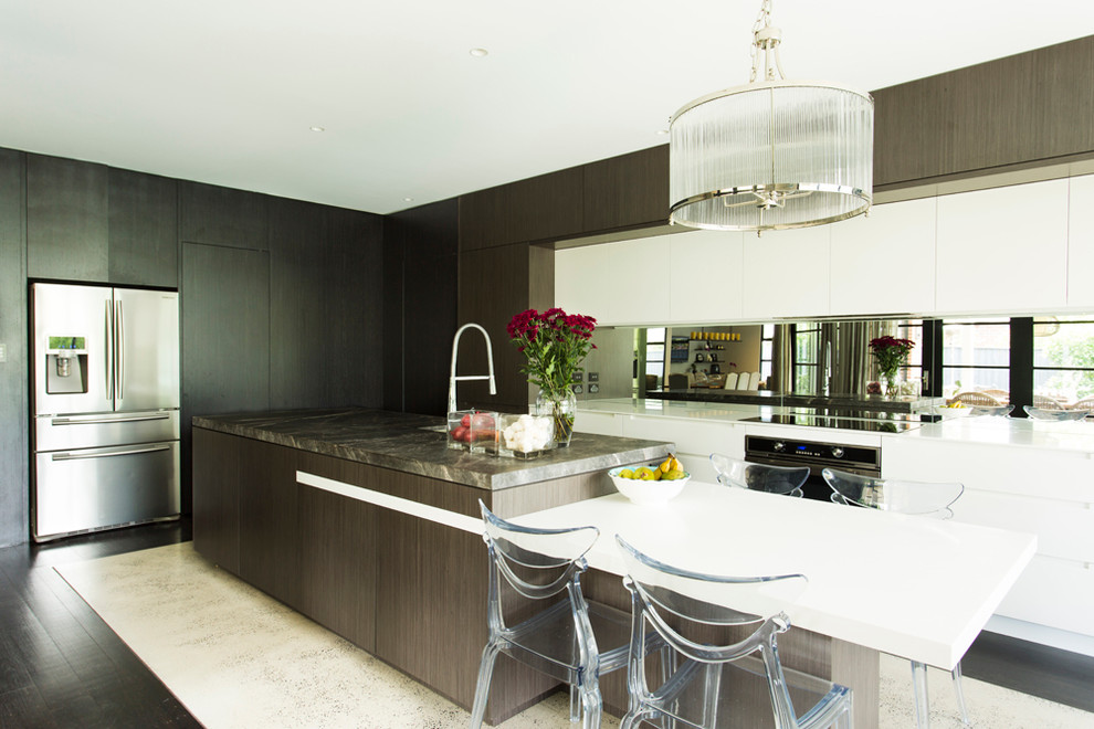 This is an example of a contemporary kitchen in Sydney with a double-bowl sink, dark wood cabinets, marble benchtops, glass sheet splashback, stainless steel appliances, concrete floors and with island.