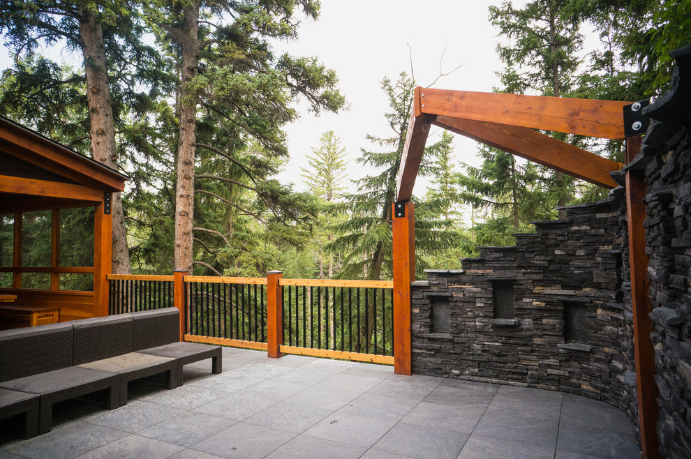 Deck - rustic backyard deck idea in Calgary