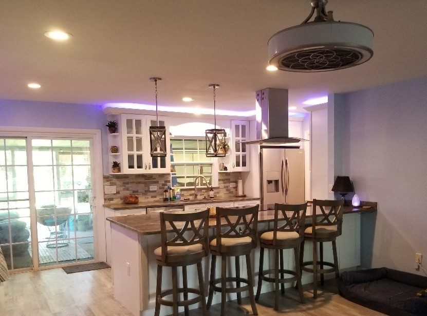 Design ideas for a mid-sized transitional galley eat-in kitchen in Orlando with shaker cabinets, white cabinets, quartz benchtops and a peninsula.