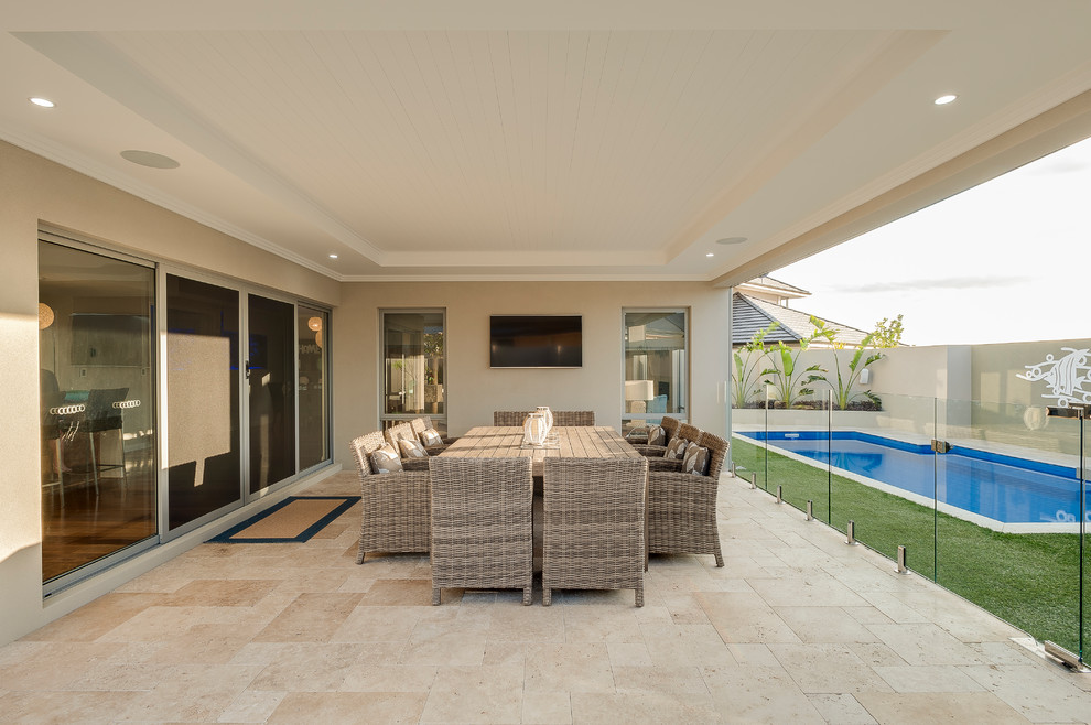 Photo of a contemporary backyard patio in Perth with natural stone pavers and a roof extension.