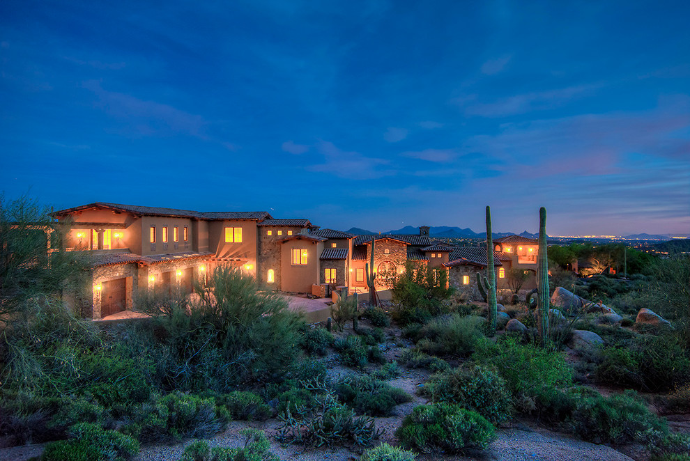 Example of a large transitional beige two-story stucco gable roof design in Phoenix