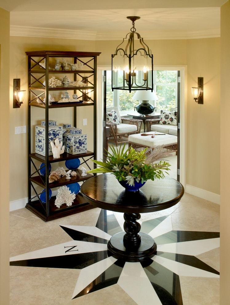Inspiration for a tropical foyer in Boston with beige walls, marble floors and beige floor.