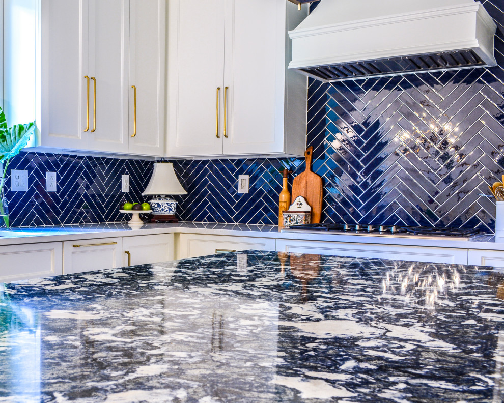 Enclosed kitchen - mid-sized transitional l-shaped medium tone wood floor and brown floor enclosed kitchen idea with an undermount sink, flat-panel cabinets, white cabinets, quartz countertops, blue backsplash, porcelain backsplash, stainless steel appliances, an island and white countertops