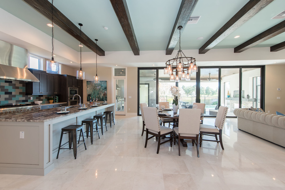 This is an example of a transitional open plan dining in Orlando with beige walls, no fireplace and white floor.