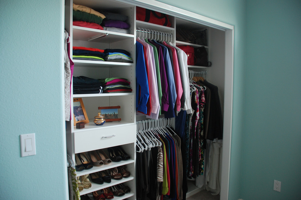 Inspiration for a small built-in wardrobe in Denver with flat-panel cabinets and white cabinets.