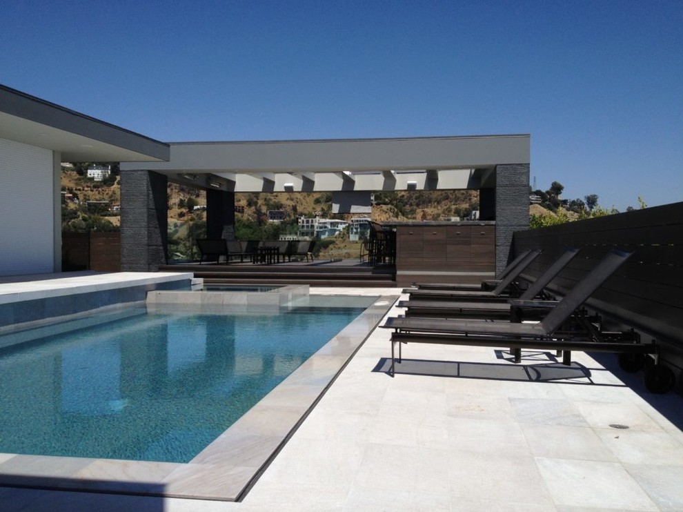 Photo of a mid-sized modern backyard rectangular lap pool in Los Angeles with a hot tub and concrete slab.
