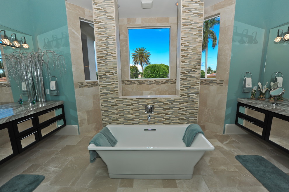 Inspiration for a beach style master bathroom in Miami with an integrated sink, glass-front cabinets, dark wood cabinets, granite benchtops, a freestanding tub, a double shower, a one-piece toilet, multi-coloured tile, mosaic tile, blue walls and marble floors.