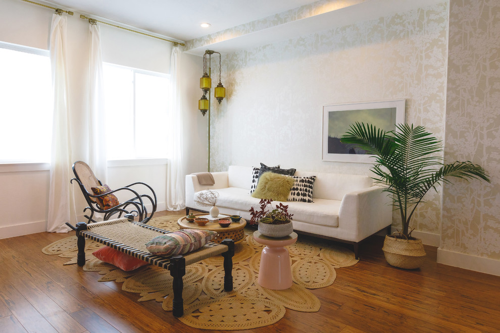 Example of a mid-sized eclectic open concept medium tone wood floor and brown floor living room design in Austin with beige walls