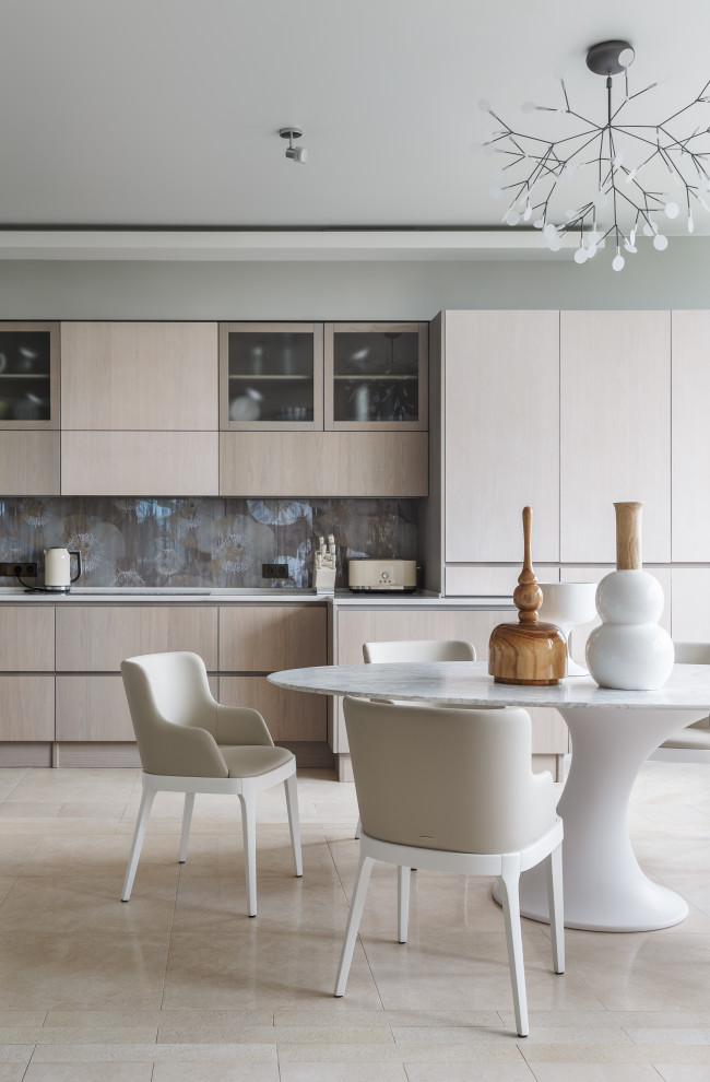 Photo of a contemporary eat-in kitchen in Moscow with flat-panel cabinets, light wood cabinets, grey splashback, beige floor and white benchtop.