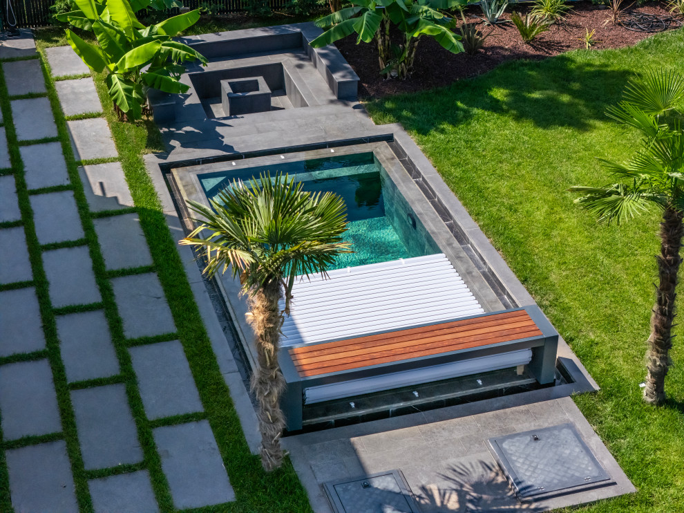 Inspiration for a mid-sized contemporary backyard decomposed granite and rectangular infinity pool landscaping remodel