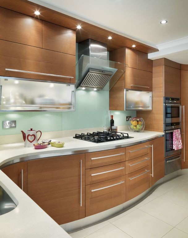 Medium sized contemporary open plan kitchen in London with a single-bowl sink, medium wood cabinets, composite countertops, white splashback, glass sheet splashback, black appliances, porcelain flooring and no island.