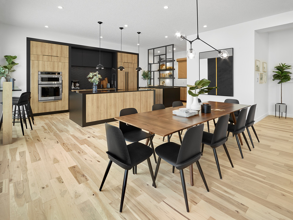 Trendy light wood floor and beige floor kitchen/dining room combo photo in Edmonton with white walls