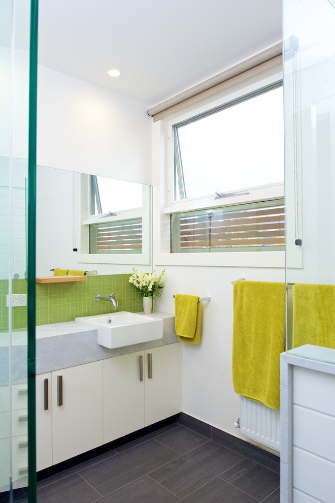 This is an example of a contemporary bathroom in Melbourne with flat-panel cabinets, white cabinets, green tile, mosaic tile, white walls and grey benchtops.
