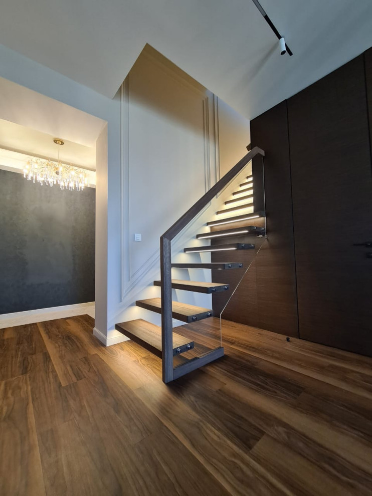 Photo of a mid-sized contemporary wood straight staircase in Other with wood risers and glass railing.