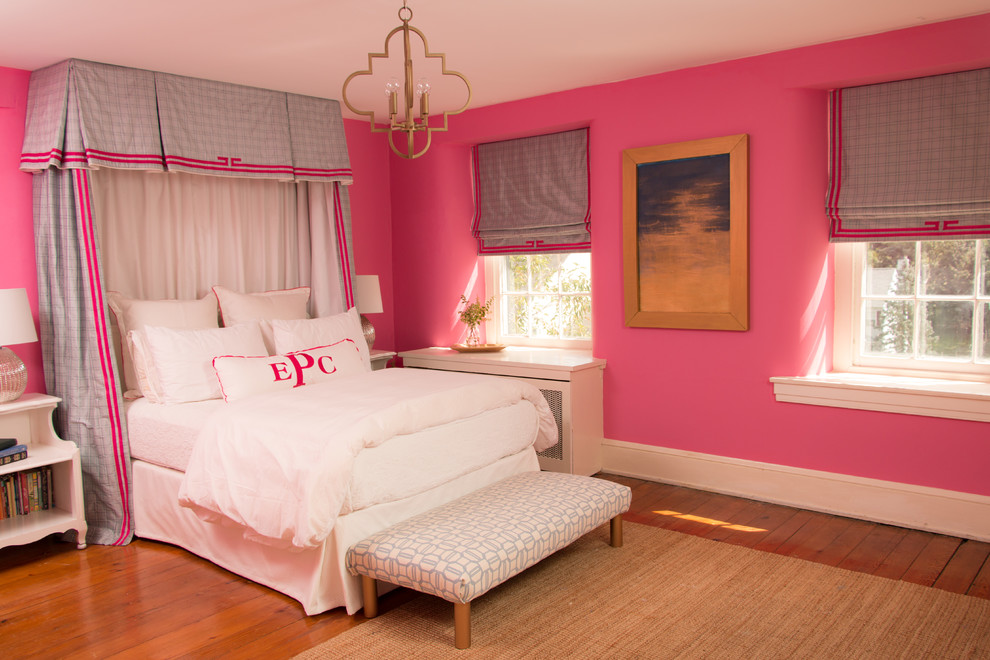 Photo of a mid-sized transitional kids' room for girls in Philadelphia with pink walls and medium hardwood floors.