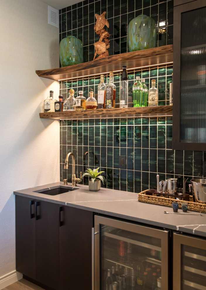 Example of a large transitional laminate floor, beige floor and wall paneling basement design in Denver with a bar and green walls