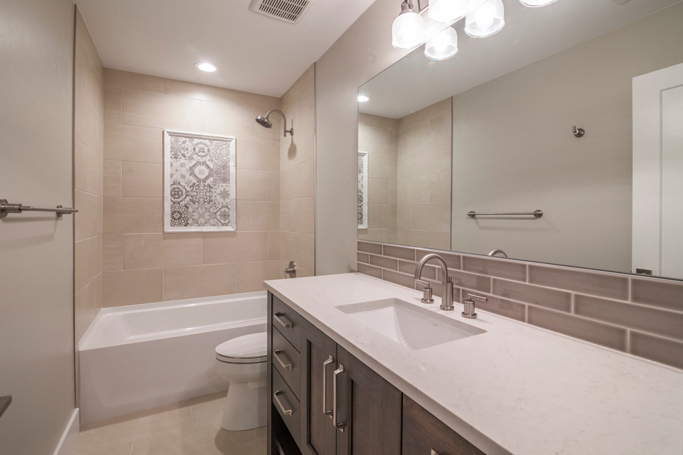 Inspiration for a mid-sized transitional 3/4 bathroom in Denver with recessed-panel cabinets, dark wood cabinets, a corner tub, a corner shower, white tile, subway tile, beige walls, ceramic floors, a drop-in sink and marble benchtops.
